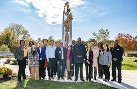 A photo of County Executive Calvin Ball and others at the unveiling of the new bronze and stainless steel sculpture at the County’s COVID-19 memorial at the Meadowbrook Park in Ellicott City.