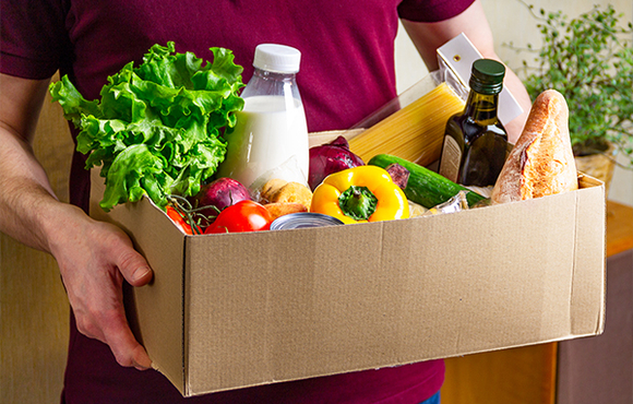 man holding a box of food