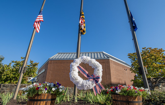 A photo of the County's September 11th Remembrance wreath set up in front of the flag poles out front of the County's George Howard Building in Ellicott City.