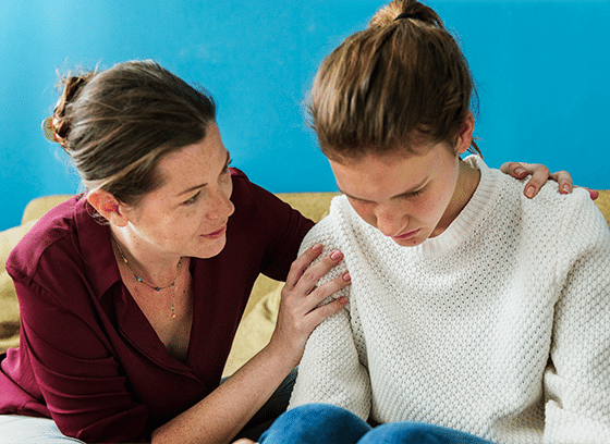 Mother consoling her distraught daughter