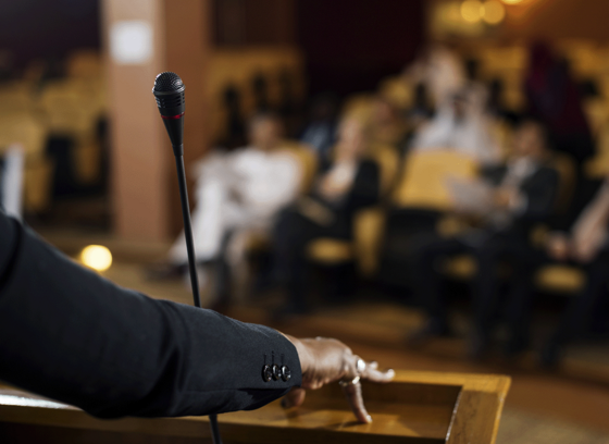 A woman giving a speech from a podium