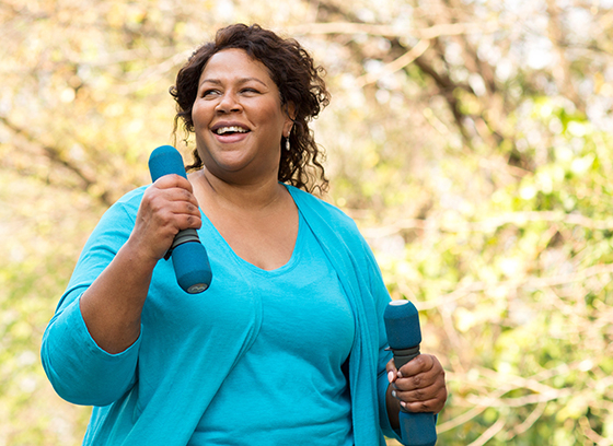 Lady holding weights whilst walking