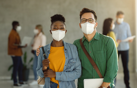 African American female and white male wearing medical masks