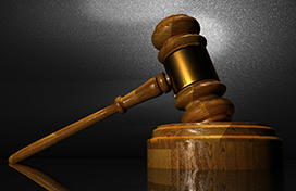 A judge's gavel resting on the podium
