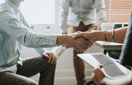 Two people in a job interview shaking hands