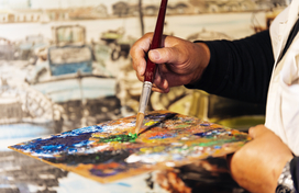 close up of male artist painting oils