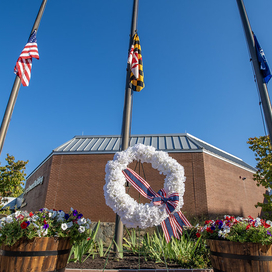 A photo of the County's September 11th Remembrance wreath set up in front of the flag poles out front of the County's George Howard Building in Ellicott City.